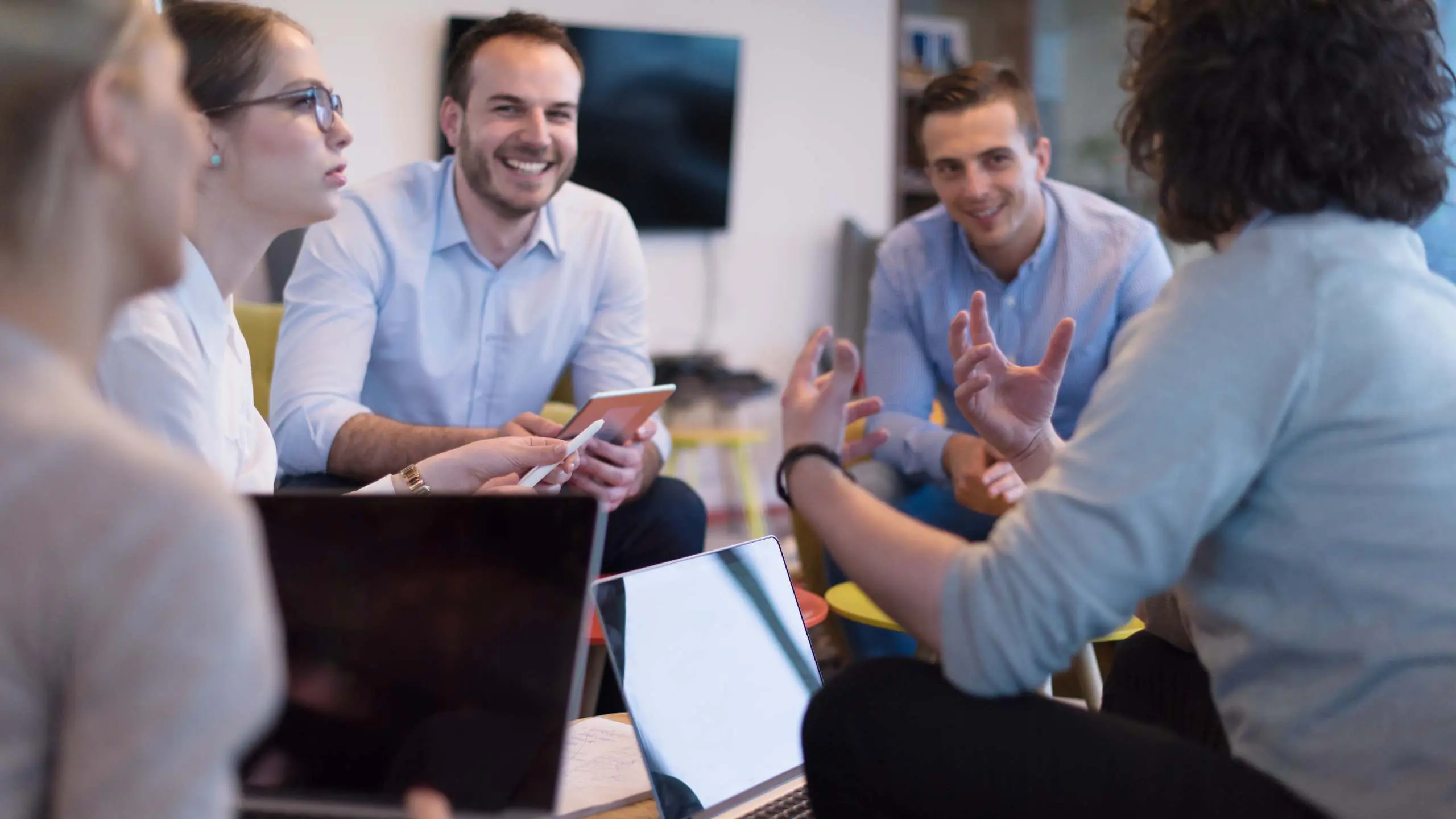 Group of a young business people discussing business plan at modern startup office building